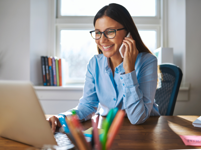 Smiling woman looking at a website.