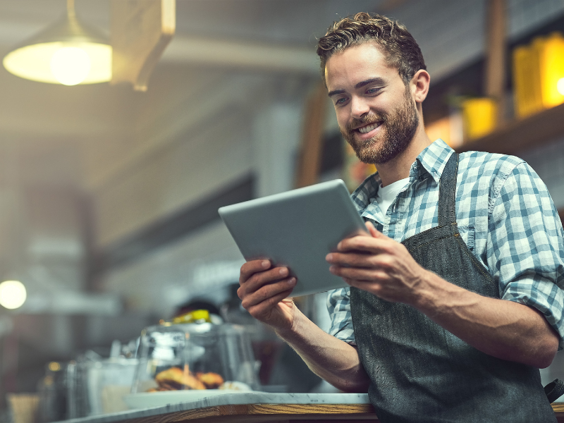 Restaurant owner looking at a tablet