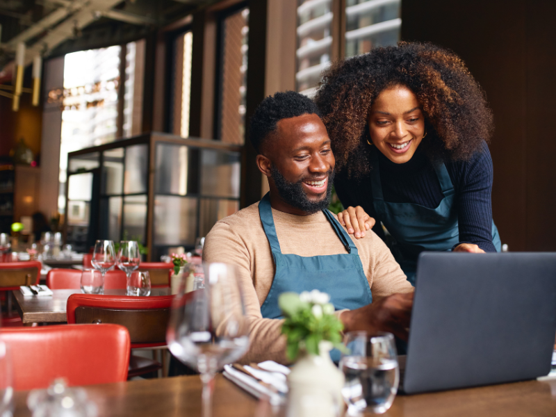 Business owners looking at a website on a laptop