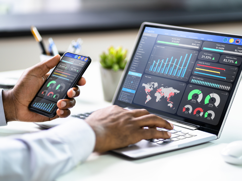 Person examining analytics on a laptop and a mobile phone